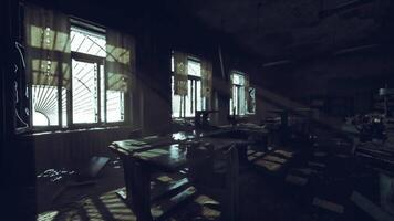Abandoned classroom with sunlight filtering through dusty windows video