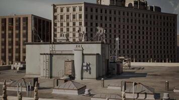 Rooftop view of urban buildings with antennas and structures during the day video