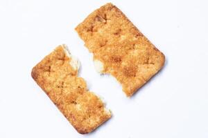 Broken stem ginger biscuits with crumbs isolated on white. Top view. photo