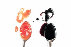 Set of different sauces with spoons isolated on white background photo