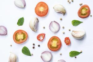 mix of slice of tomato, basil leaf, garlic and spices photo
