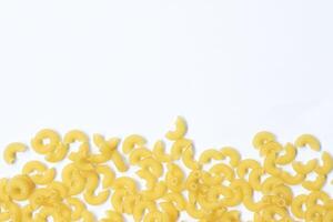 raw macaroni pasta isolated on white background with full depth of field. Top view. Lay flat photo