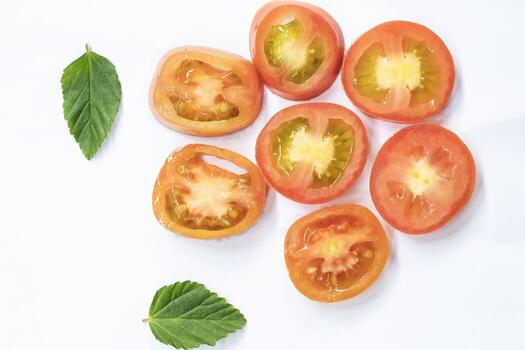 Top view of isolated tomato slices. Tomatoes on a white background. Set of round tomato slices. With clipping path. photo