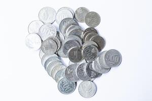 A stack of coins in isolation on a white background top view photo