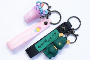 anime and cartoon key chains, key chains are small metal rings or chains that can be attached to several keys. photo