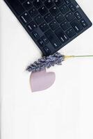 Business concept. Top view photo of flower workplace keyboard computer mouse reminder on isolated white background with copy space in the middle