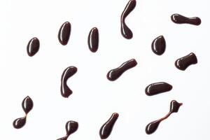Chocolate syrup drop isolated on white background. Top view photo