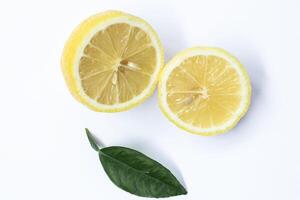 Isolated lemon. One whole lemon fruit and a half isolated on white background photo