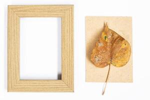Autumn composition. Photo frame, maple leaves, on white background. Flat lay, top view, copy space.