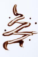 Abstract pattern made of chocolate on white background photo