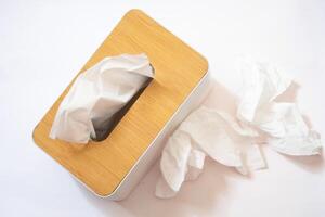 Holder with paper tissue on white background, top view. Space for text photo
