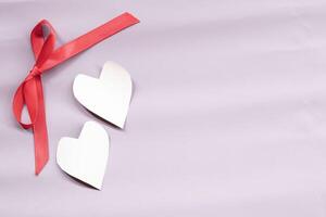 Valentine's day frame composition. Red heart on pastel pink background. Top view, flat lay, copy space. Invitation card design template, from above. photo