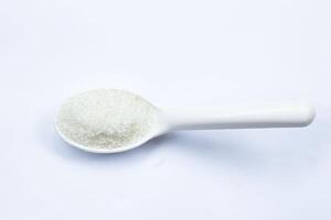 One teaspoon of sugar on a white background isolated top view photo