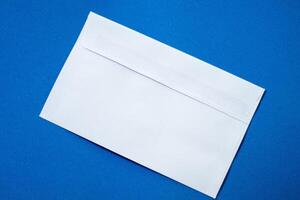 Set of white envelopes sealed, empty and with blank paper inside, isolated on a blue background photo