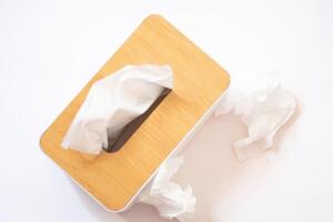 Holder with paper tissue on white background, top view. Space for text photo