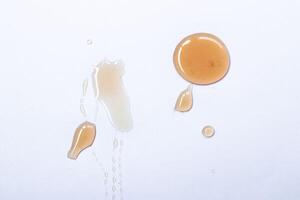 Honey drops isolated on white background close up. photo
