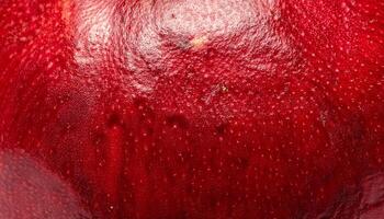 macro close-up of pomegranate peel featuring its thick leathery red texture and glossy surface details photo