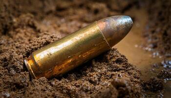 close-up of a bullet casing partially buried in muddy soil, showcasing tarnished brass and environmental impact in a wet terrain photo