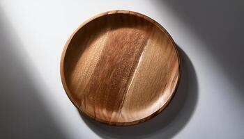 close-up of a round wooden plate on a plain white background with natural wood texture for food and product display photo