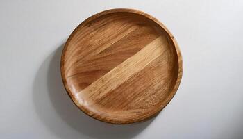 top view of a round wooden plate with natural wood grain pattern on plain white background for product display or branding photo