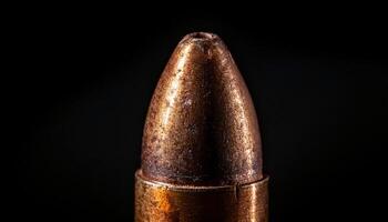 macro view of aged bullet with engraved markings and textured metallic surface against dark background photo