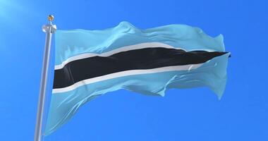 Botswana flag waving at wind in slow with blue sky, loop video
