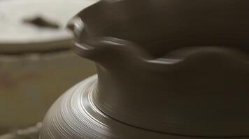 Vase of mud recently made by a potter craftsman spinning in the lathe video