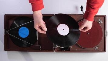 Top view Man holding a vinyl record in his hands. Man choosing what music to listen to video
