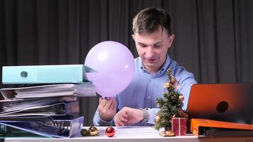Final countdown to New Year. Man at office desk celebrating New Year video