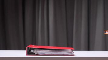 office worker puts a stack of multi-colored folders with documents on his desk video