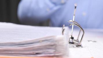Close-up Office worker browsing through documents in a binder video