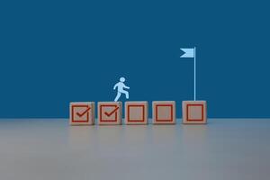 Project progress Businessman steps on task check mark to completion flag photo