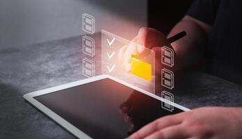 Enterprise Resource Planning concept. Document management System. Woman use digital tablet for select business data folders financial information. photo
