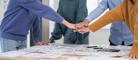 Application development team Stack of hands Working together to show unity in working on ux ui smartphone applications. photo
