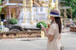 Young Female Tourist Exploring a Historic Site While Using a Mobile Phone for Navigation and Information photo