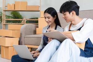 Couple Managing Online Order and Packing Products at Home for Their E-commerce Business photo