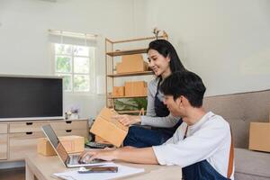 Couple Checking Merchandise Boxes for Online Delivery in a Modern Home Setting photo