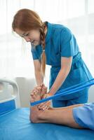 Young Caregiver assistance Elderly Patient with Physical Therapy in a Modern Healthcare Facility photo