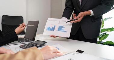 Business Team Collaborates on Data Analysis with Graphs in Modern Office Setting photo