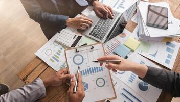 Business Team Collaborating on Financial Reports and Strategies in a Modern Office Setting photo