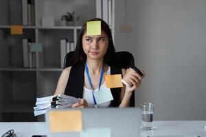 Busy Office Worker Managing Documents and Tasks in a Modern Workplace Setting photo