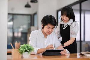 University Students Collaborating on Homework in a Modern Study Space with Digital Tablet and Notes photo