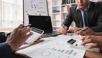 Business Team Collaborating on Financial Reports and Data Analysis in a Modern Office Environment photo