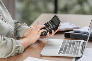 Calculating finances at home office accounting desk business workflow indoor environment close-up view productivity concept photo