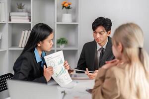Diverse Business Team Collaborating on Strategic Work Plans in a Modern Office Setting photo