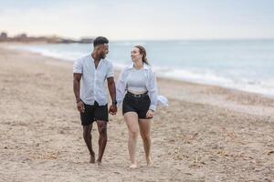 A couple strolls hand in hand along Zapillo Beach in Almeria, Spain, enjoying the tranquil seaside experience together photo