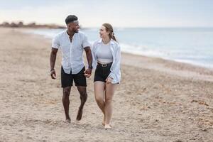 A couple strolls hand in hand along Zapillo beach in Almeria, Spain, enjoying a peaceful moment by the sea photo