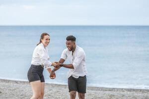 Joyful moments at Playa del Zapillo in Almeria, Spain, as a couple enjoys playful interaction by the serene beach photo