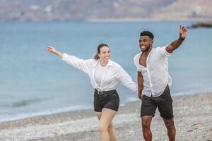Couple enjoying a playful moment together on the sandy shores of Playa del Zapillo in Almeria, Spain during a sunny day photo