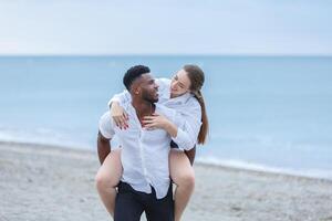 A joyful couple enjoying a playful moment together at Zapillo Beach in Almeria, Spain during the late afternoon photo
